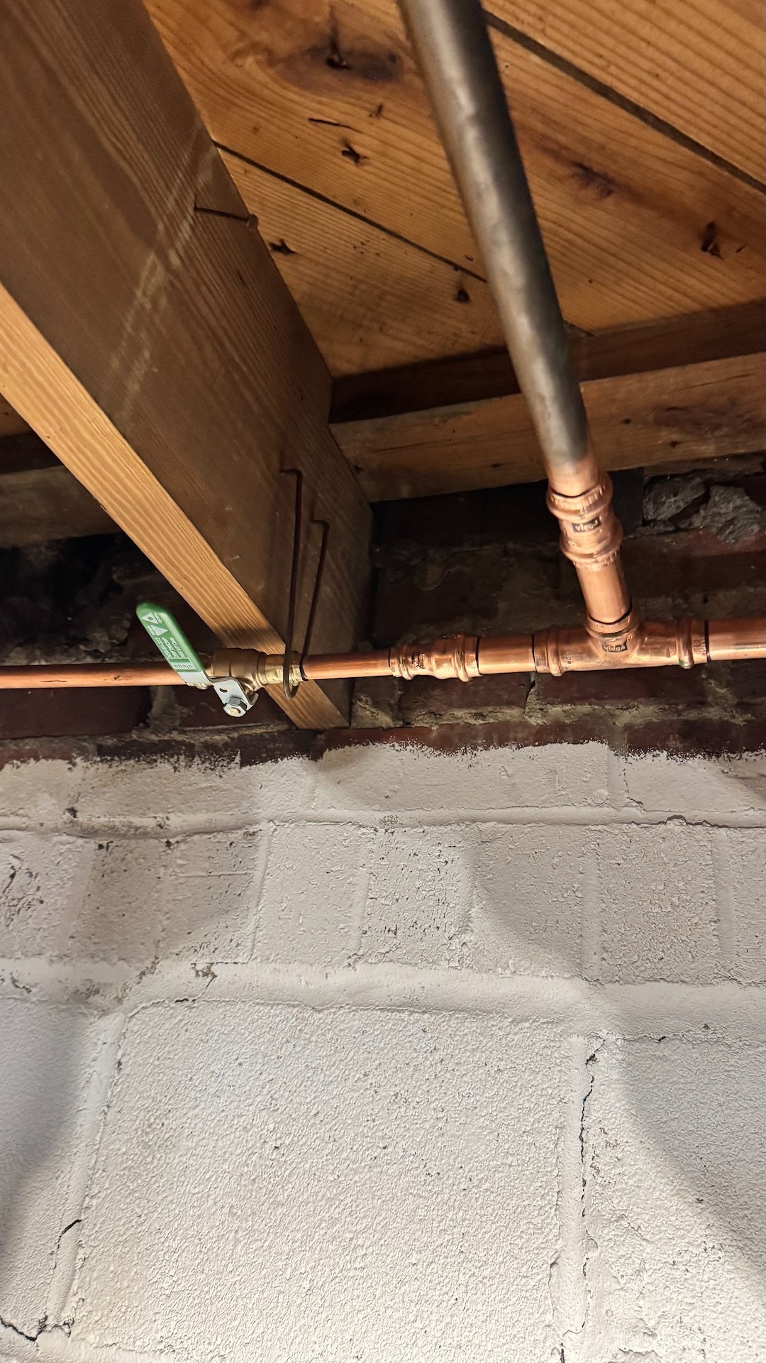 Clean, code-compliant copper pipe repair in a basement ceiling in Alexandria, VA